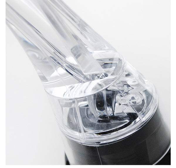 Close-up of a transparent wine aerator gadget, perfect for enhancing wine flavor and aroma.