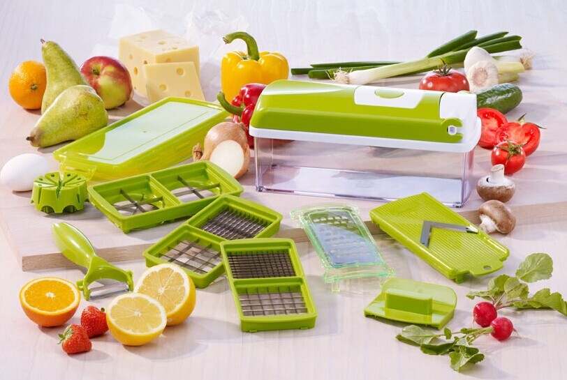 12-piece multifunctional vegetable chopper set with various slicers and dicers on kitchen counter.