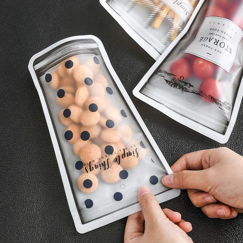 Durable silicone cup-shaped reusable ziplock bags filled with snacks.