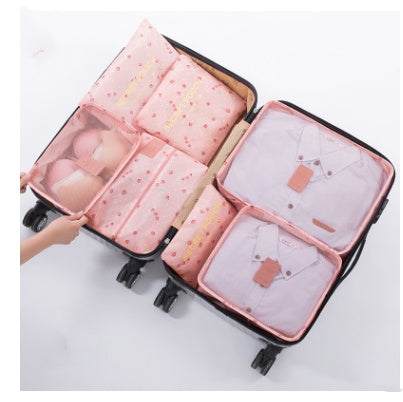 Pink nylon travel packing cubes set in suitcase, waterproof and organized.