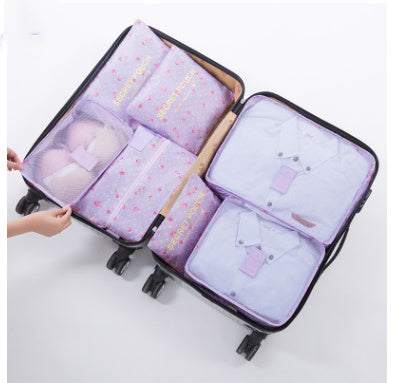 Nylon packing cubes organize clothes in suitcase.