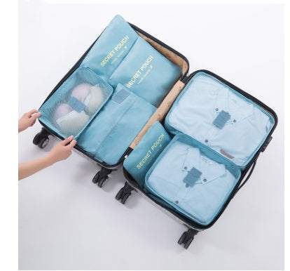 Blue durable waterproof nylon packing cubes inside an open suitcase.