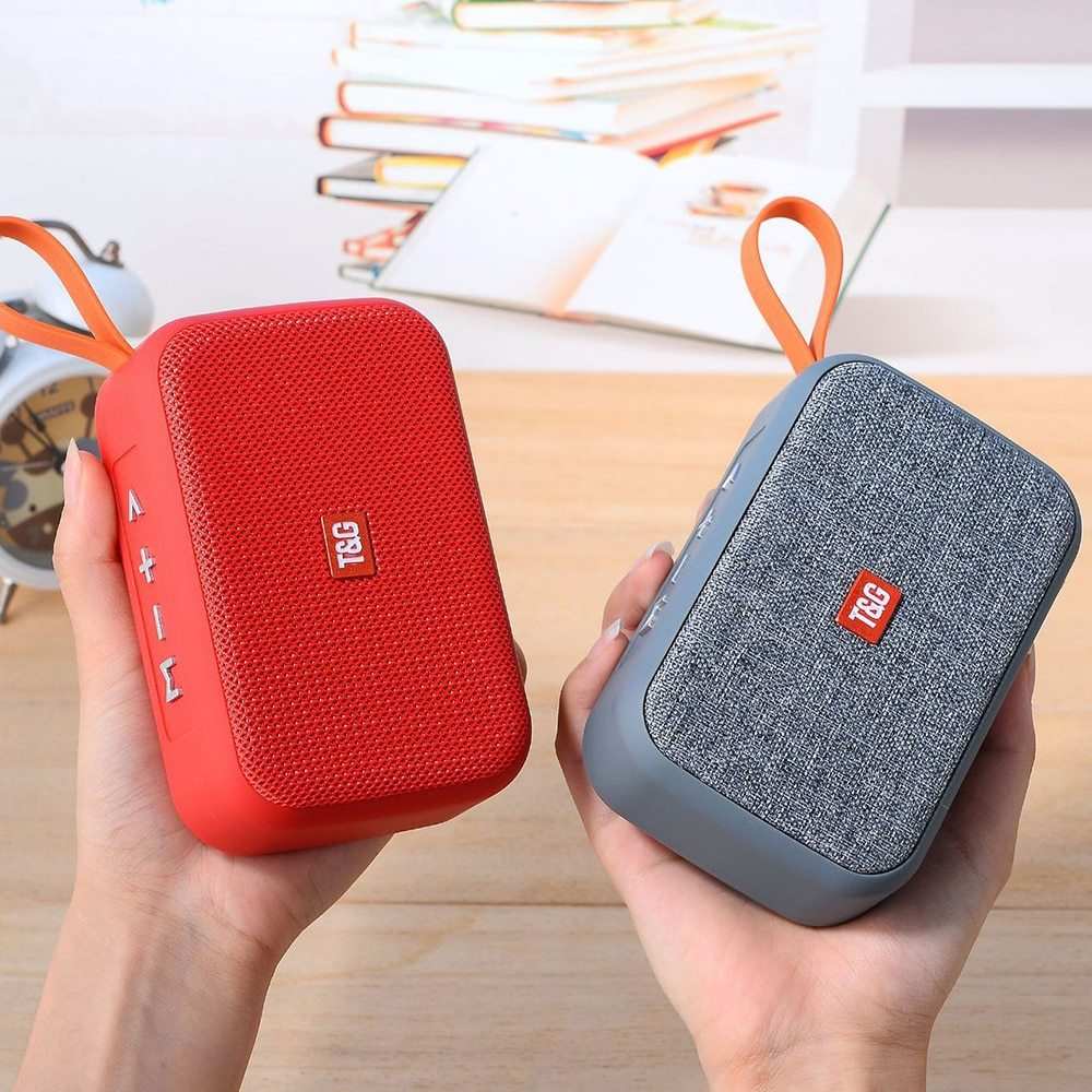 Compact sports wireless Bluetooth speakers with call and radio functionality, available in red and gray, held in hands.