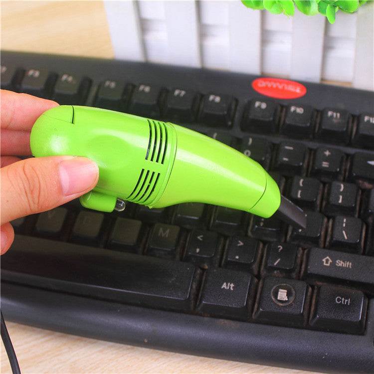 Mini vacuum cleaner for keyboards being used.