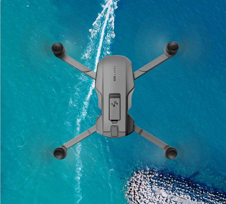 GPS drone with HD camera and stabilizing gimbal flying over ocean.