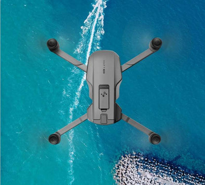 GPS drone with HD camera and stabilizing gimbal flying over ocean.