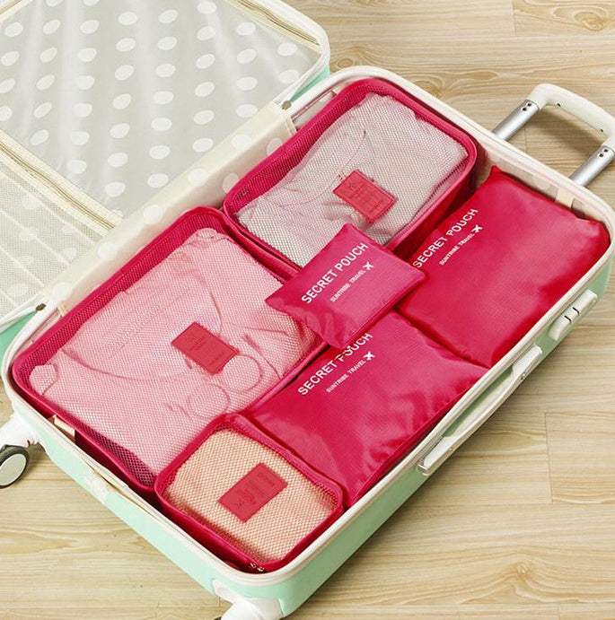 Durable waterproof nylon packing cubes arranged in an open suitcase, showcasing pink travel organizer bags.