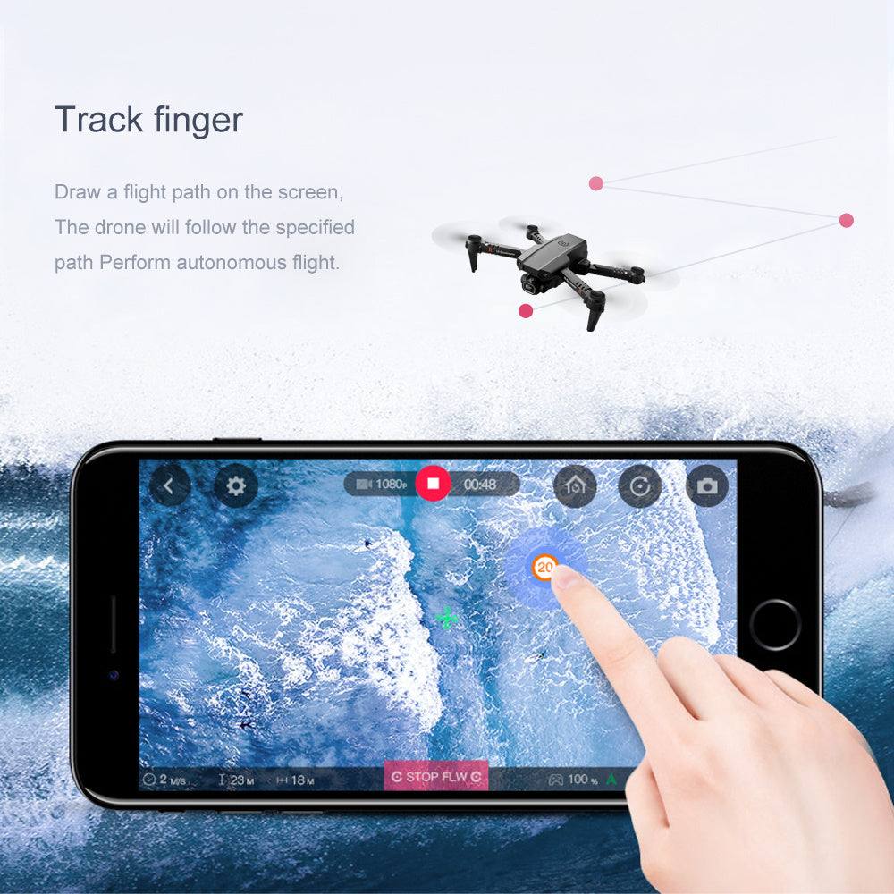 Mini drone with aerial photography capability, black color, showing track finger feature on smartphone screen.