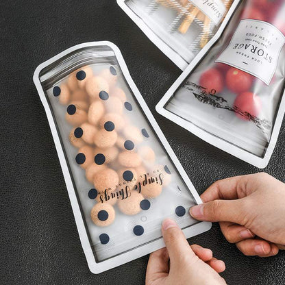Durable silicone cup-shaped reusable ziplock bags filled with snacks.