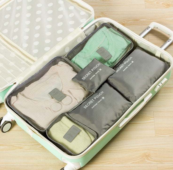 Durable waterproof nylon packing cubes in suitcase, various sizes and colors for organizing travel items.