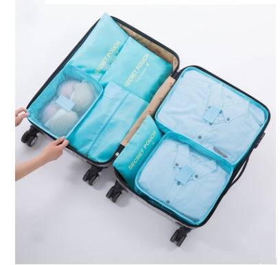 Durable waterproof nylon packing cube travel organizer bag set in various sizes inside suitcase.