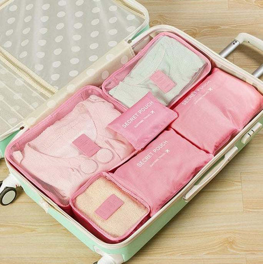 Waterproof nylon packing cubes in suitcase, assorted pastel colors, organized for travel.