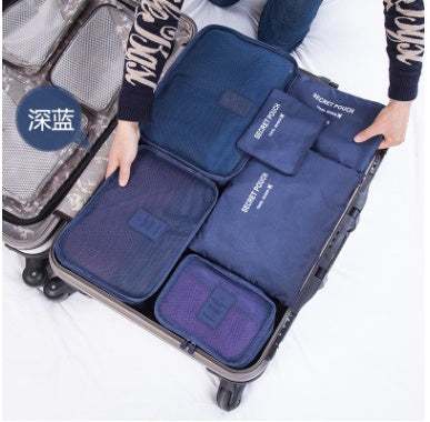 Navy blue waterproof nylon packing cubes in suitcase, travel organizer set.