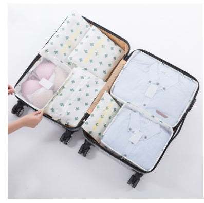 Nylon packing cubes inside an open suitcase, organizing clothing and accessories.