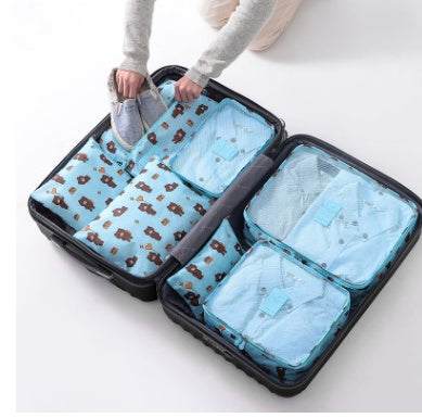 Travel suitcase with light blue waterproof nylon packing cubes for organized storage.