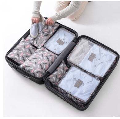 Travel organizer bag set with waterproof nylon packing cubes neatly placed in luggage.